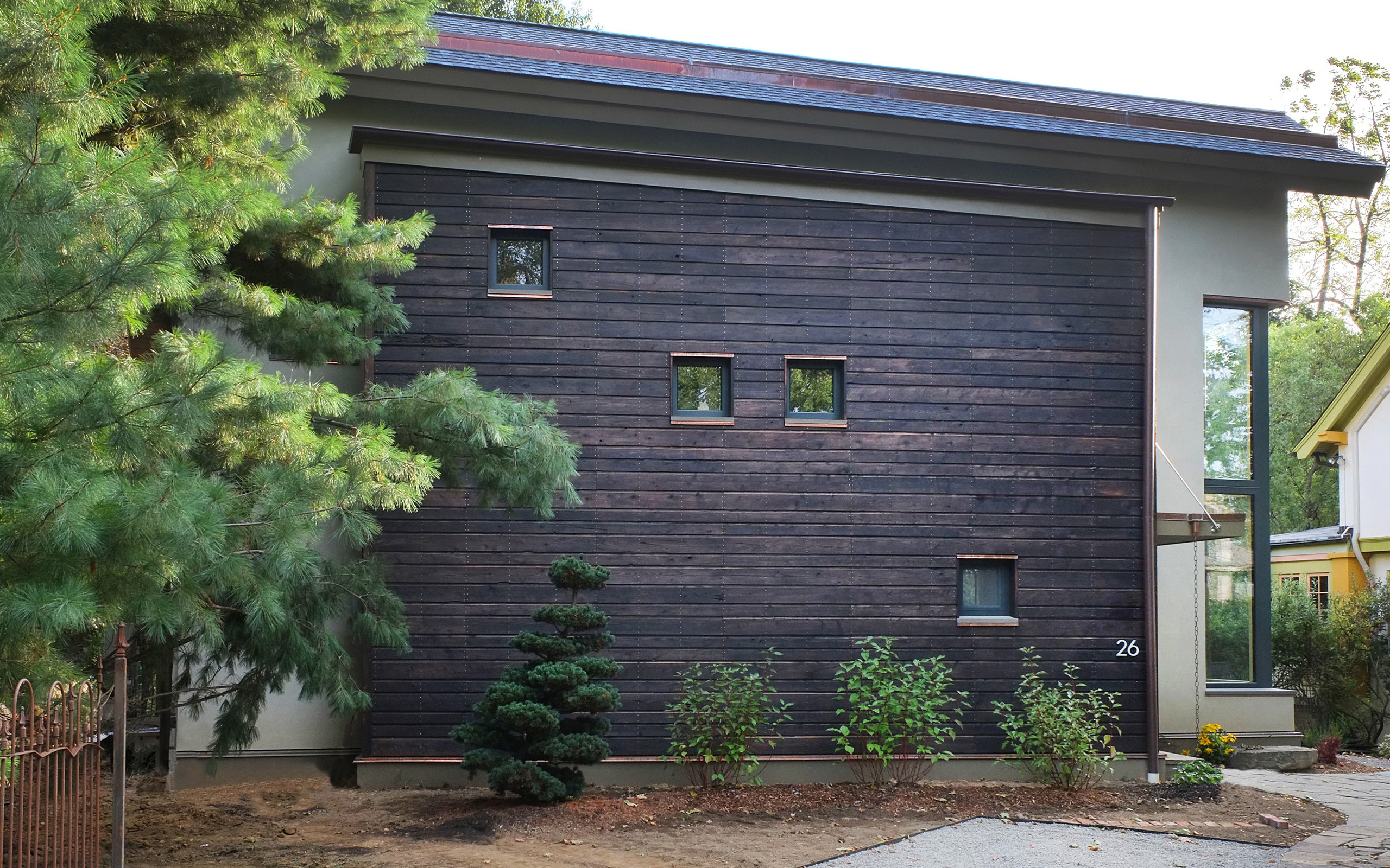 Wood paneling and windows on side of Ellman-Raiselis Passive House