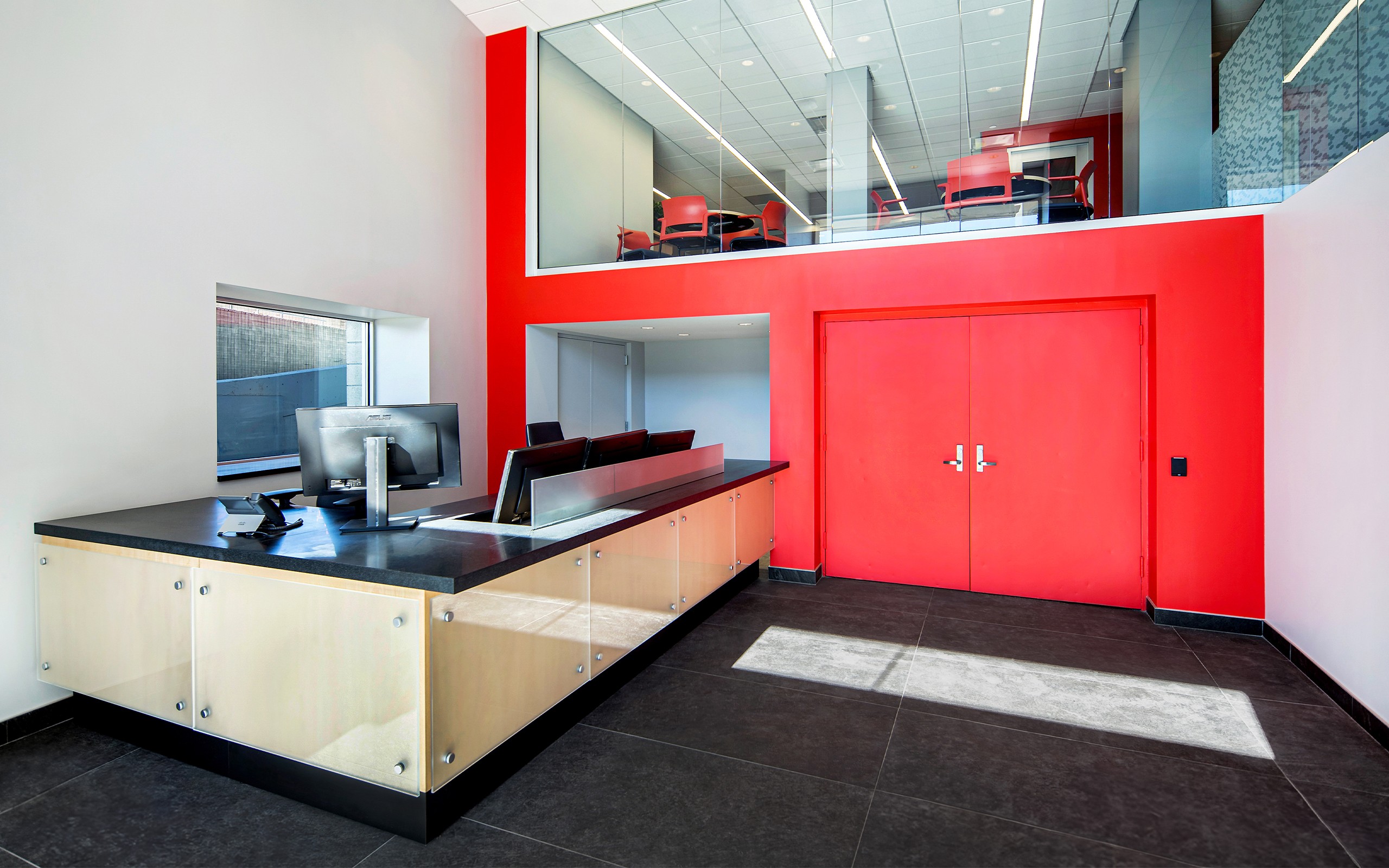 Jacob K. Javits Convention Center custom designed security desk at Staff Entry area. Storefront system at Executive Administrative level above provides a connection between the two spaces.