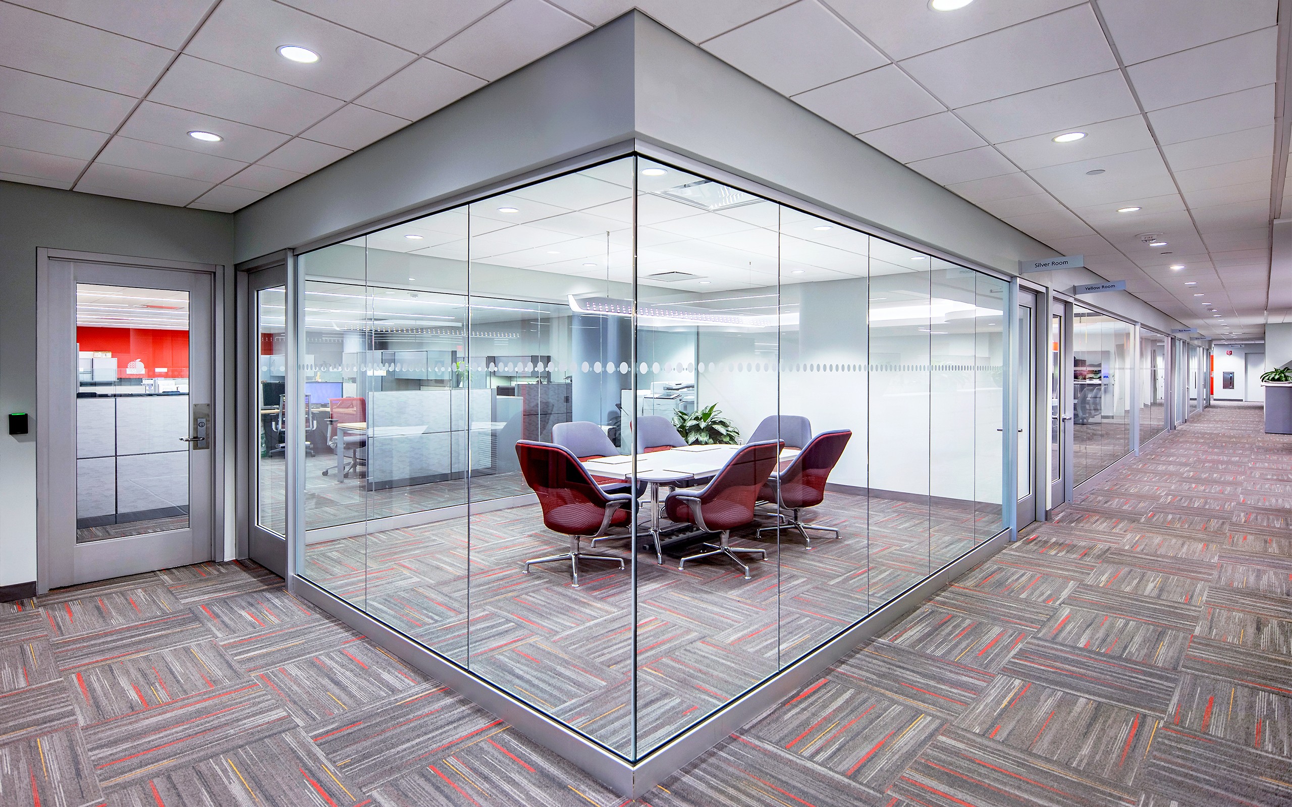 Jacob K. Javits Convention Center glass bowl conference room provides privacy but still connects to the open area workspace.