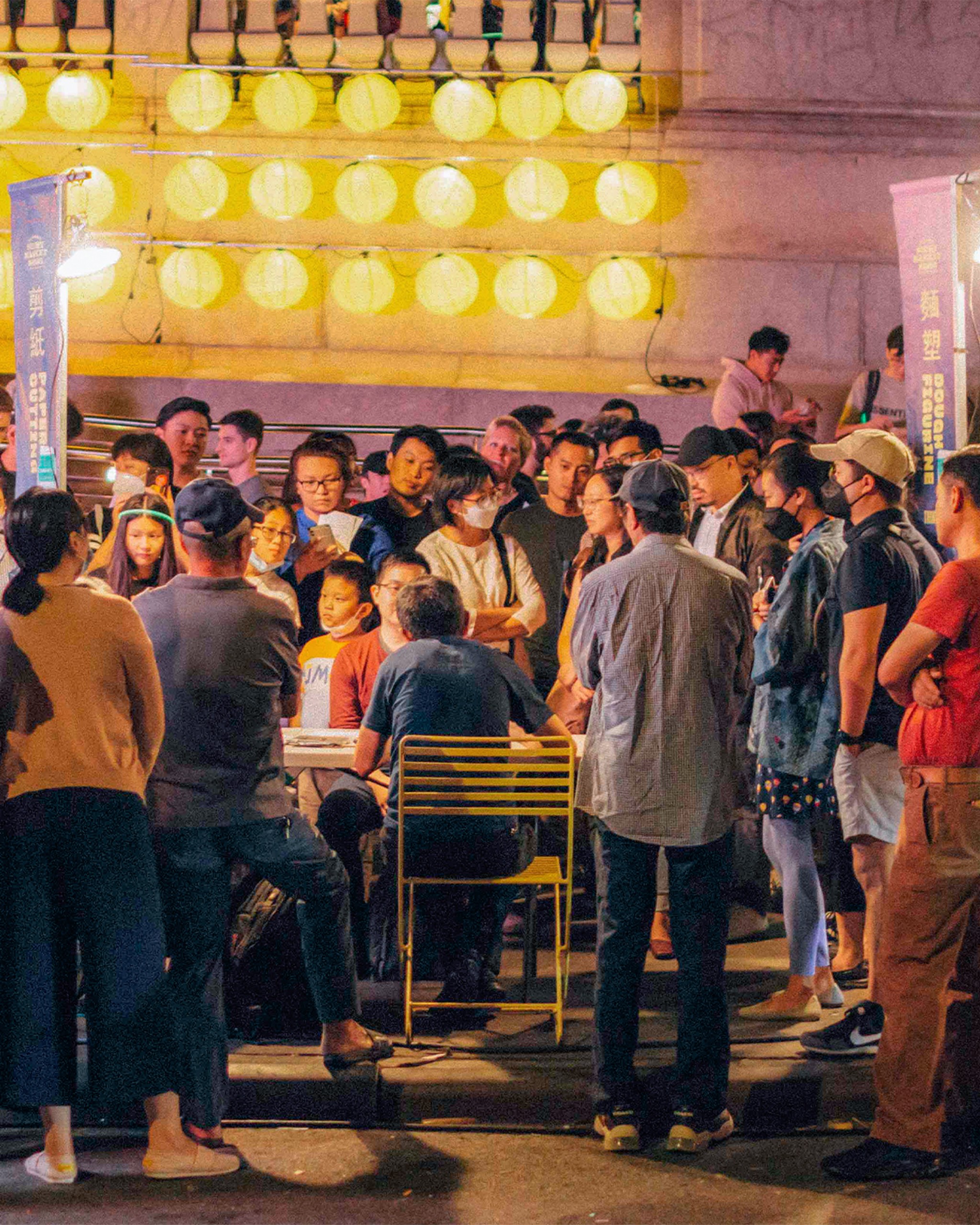 a crowd gathered around a vendor